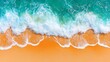 © Rendra - Aerial view of turquoise ocean waves breaking on a sandy beach.