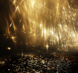 Wall Mural - abstract glitter black and gold lights background. de-focused