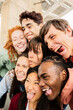 © Xavier Lorenzo - Vertical portrait of group of young gen z friends doing funny faces standing together. Youth community concept
