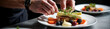 © lina - chef plating a gourmet dish with meat vegetables and herbs