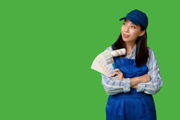 Wall Mural - female asian painter with paint color palettes and roller on green background