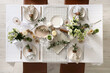 © Pixel-Shot - Beautiful table setting with eustoma flowers and eucalyptus for wedding celebration in room, top view