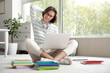 © Pixel-Shot - Beautiful student studying with laptop on floor at home