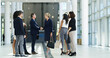 © peopleimages.com - CEO, business people and handshake in office for welcome, b2b introduction or greeting. Group, collaboration or shaking hands for agreement, deal or company merger with financial acquisition in lobby
