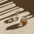 © sahina - Sunlit Still Life,  Three Glasses of Amber Liquid on Beige Fabric