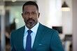 © Inspire Shots Hub - Portrait of a serious African American man in a teal suit and light blue shirt, showcasing professionalism and confidence in a business setting