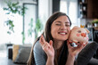 © Migma_Agency - Happy woman holding piggy bank crossing fingers hoping for financial success