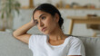 © Yuliia - Close up boring sad upset frustrated thinking suffer disappointed bored think pensive thoughtful Hindu woman Indian girl Arabian female lady at home couch problem at sofa confused puzzled hesitate