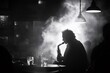 © Gatherina - Silhouette of musician playing saxophone in smoky jazz club