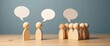 © AkuAku - Wooden figure standing out among a group of diverse individuals, conversation concept, Wooden figurine with dialogue bubble, Distinct human form, Leadership, Human resource.