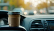 © charli - Close-up of a coffee cup in a car interior  -