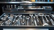 © Sirinya - A detailed macro shot of polished chrome mechanic tools in an organized toolbox, showcasing their quality and durability.