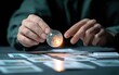 © creatfive - Close-up of hands holding a glowing crystal orb above a spread of cards on a dark surface.  Intriguing and mysterious atmosphere