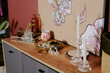 © AnnaStills - High angle shot of wooden dresser with wax candles, accessories and painting on top, copy space