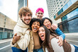 © Davide Angelini - Happy multiracial friends having fun on city street - Group of young people smiling at camera outside - Friendship concept with guys and girls walking in downtown road