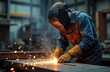 © Maryna - Welder welding metal with sparks. Workshop scene with worker wearing protective mask, gloves. Manufacturing industry, construction job. Welding equipment, steel structure, ironwork, fabrication.