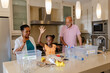 © Wavebreak Media - Sorting recyclables in kitchen, grandparents teaching granddaughter environmental responsibility
