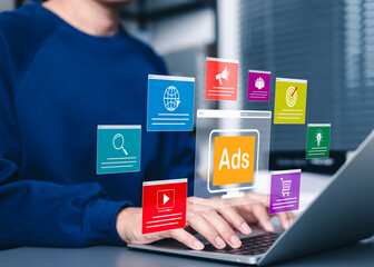 digital marketing ads on website interface. a person using laptop with ad icons representing online 
