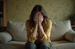 © Maryna - Woman, face covered, sitting sofa. Depression, mental health concept. Sad female experiences emotional distress, suffering from overwork, stress, loneliness, frustration. Indoor shot of overwhelmed
