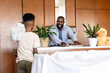 © Wavebreak Media - Father and son enjoying playful moment at home with plants and teddy bear