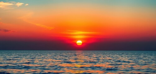 Wall Mural - golden sun dips below horizon, fiery hues reflected in calm sea, golden, tranquil, peaceful