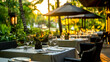 © ABF_MATEO - Elegant outdoor dining experience with lush greenery and sunset lighting, creating a warm and inviting atmosphere for guests.