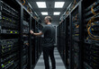 © kristina - A man working in a server room full of computers and cables, monitoring screens and connecting wires meticulously.