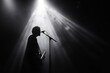 © Oleh - Musician singing and playing bass guitar under stage lights
