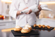 © New Africa - Professional pastry chef making desserts at table in kitchen, closeup