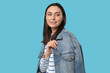 © Pixel-Shot - Beautiful young happy woman in stylish denim jacket on blue background