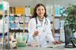 © JackF - Portrait of positive female pharmacist working at computer in a pharmacy