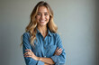 © Viktor - Portrait of smiling young woman with long blonde hair in blue shirt. Confident female crossed arms, looking at camera. Studio shot, natural light. Happy model in casual attire shows positivity.