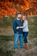 © Cavan - Husband and wife stand together smiling in pretty autumn field