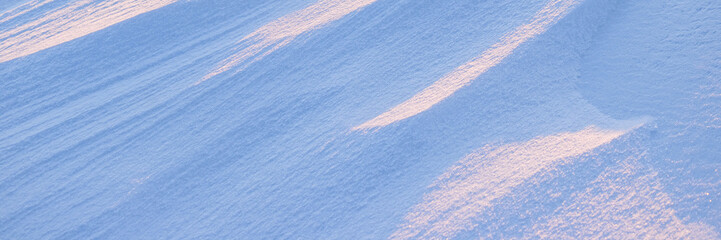 Wall Mural - Snow texture. Wind sculpted patterns on snow surface. Wind in the tundra and in the mountains on the surface of the snow sculpts patterns and ridges. Arctic, Polar region. Winter panoramic background.