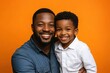 © nian - Portrait of happy african american father and son on color background. Ai generated.