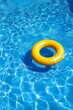 © Andrei - Yellow Inflatable Ring Floating in a Sparkling Blue Swimming Pool, Summer Fun and Relaxation Concept