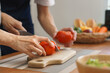 © STBSTD - Smiling young couple preparing fruits and vegetables together in bright kitchen sharing joyful cooking experience