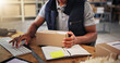 © peopleimages.com - Hands, man typing with box for distribution of inventory management, online order and stock. Person, keyboard and package report of supply chain, quality control and information for delivery schedule