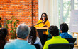 © StockImageFactory - Indian Asian Confident life coach addressing entrepreneurs at a business event with a microphone