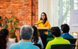 © StockImageFactory - Indian Asian Confident life coach addressing entrepreneurs at a business event with a microphone