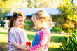 © Austockphoto - Two little girls in pink playing outside together