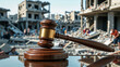 © Syuhuud - A wooden judge’s gavel with a golden band resting on a polished sound block, placed on a reflective surface. In the background, a war-torn city with destroyed buildings and civilians seeking refuge