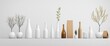 © milenialdesastudio - Minimalist arrangement of white bottles, vases, and plants against a light backdrop