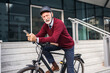© Jelena - Senior Man with Bicycle Using Smartphone in Urban Setting