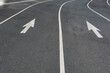 © Mint Images - Two directional Arrow symbols on the road surface, on a city road in Seattle.