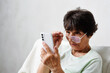 © Oksana Klymenko - Confused elderly woman in eyeglasses has problem with bad vision, blurry sight reading on mobile phone. Check eyesight