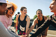 © Jacob Lund - Diverse team huddle showing support and encouragement at a marathon