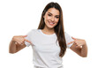 © Over View - Young woman pointing to her white t-shirt with fingers, showing empty space isolated on White background PNG transparent background