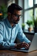 © อัญชลี โคตรธรรม - Indian businessman wearing glasses analyzing stock market data on laptop, business world, market trends