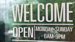 © WD Stock Photos - Glass storefront with welcome and opening hours signage